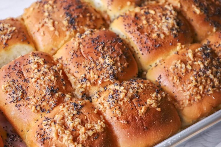 a close up of ham and cheese sliders in the pan